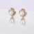 Picture of Wholesale Gold Plated White Dangle Earrings with No-Risk Return